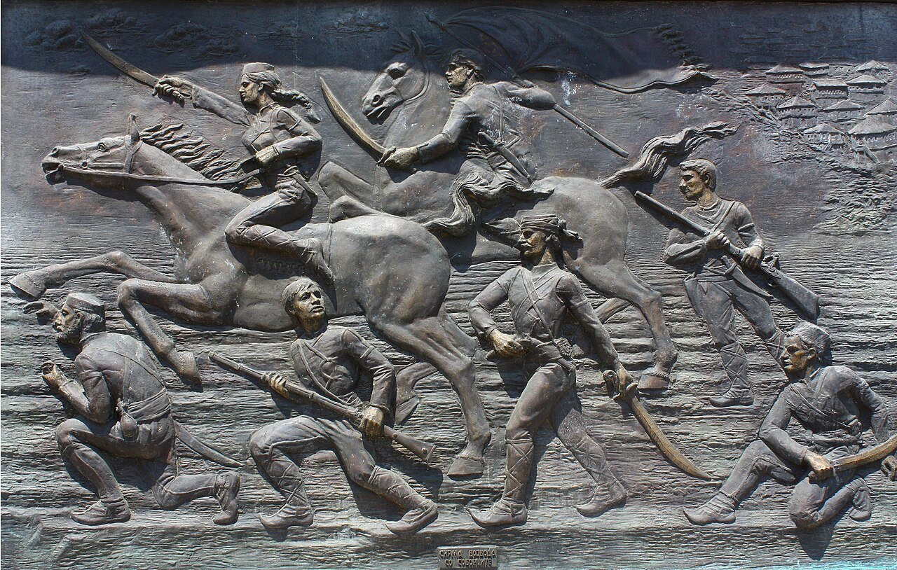 Plaque of Sirma Voyvoda (on horseback, first from left) and her troops in Skopje, North Macedonia.