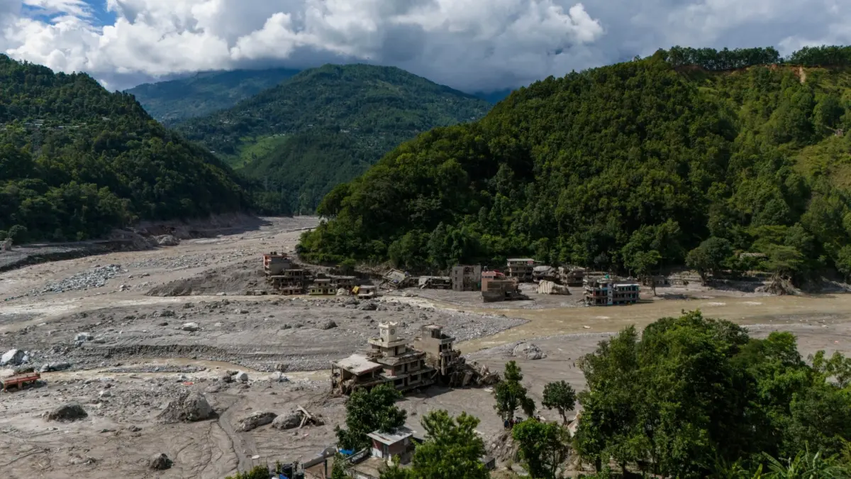 Riverbed covered in mud, house on the side. Photo by Suman Nepali of Nepali Times. Used with permission.